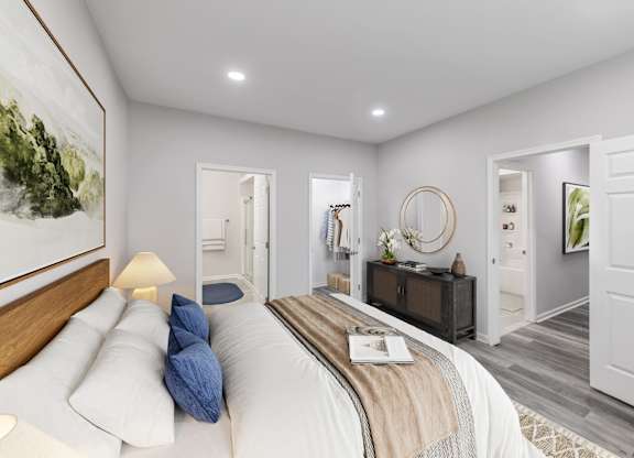 a white bedroom with a bed and a mirror