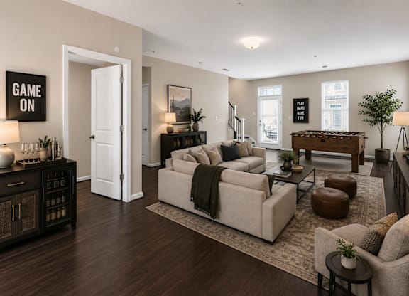 Spacious lower-level living area with open floor plan, large windows, and access to outdoor entry.