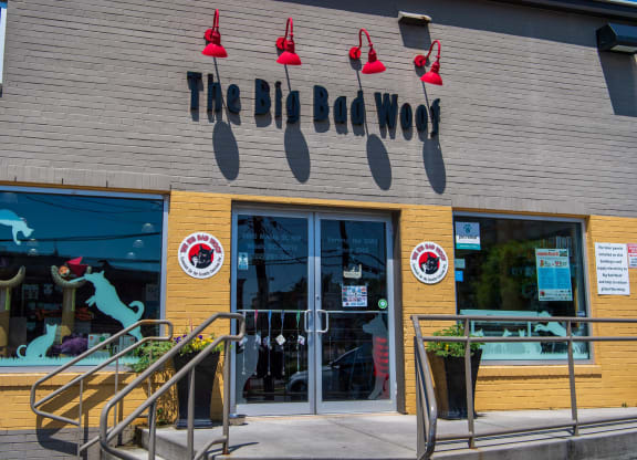 the front of a store with a glass door and a window display of a cow