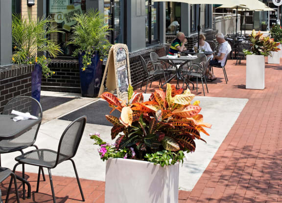 a patio with tables and chairs outside of a building
