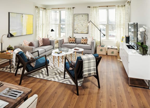 a living room with couches and chairs and a rug