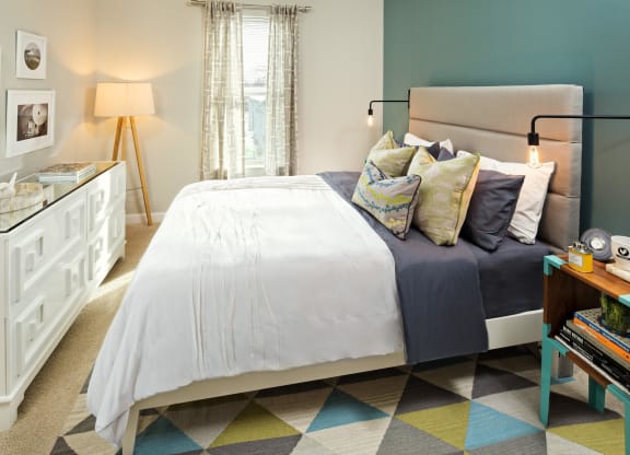 a bedroom with a bed and a dresser