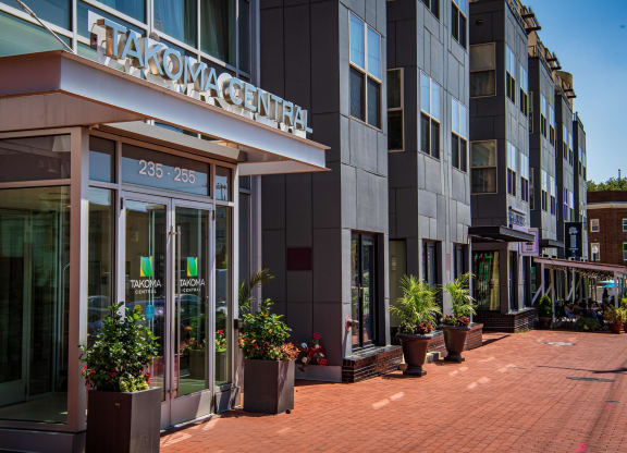 a view of the front of a building with potted plants in front of it