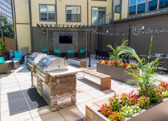 a backyard patio with a grill and a bar