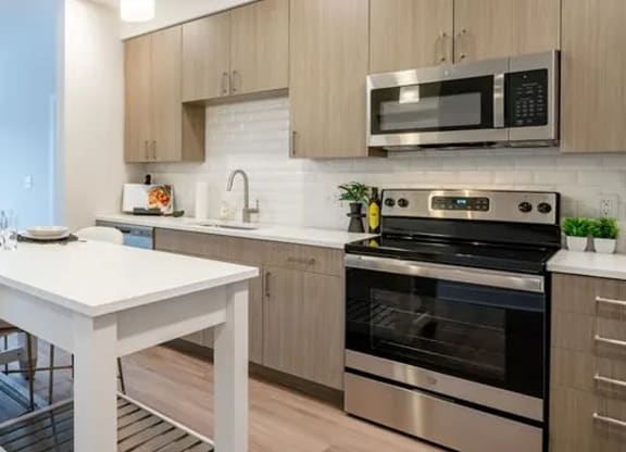 a kitchen with stainless steel appliances and a white table