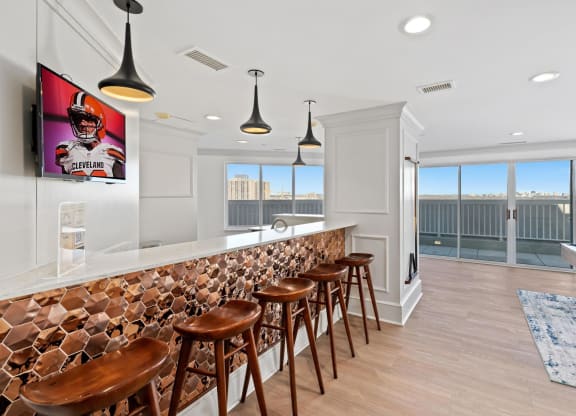 a bar with wooden stools in a room with a pool table