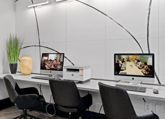 a desk with two computer monitors on it