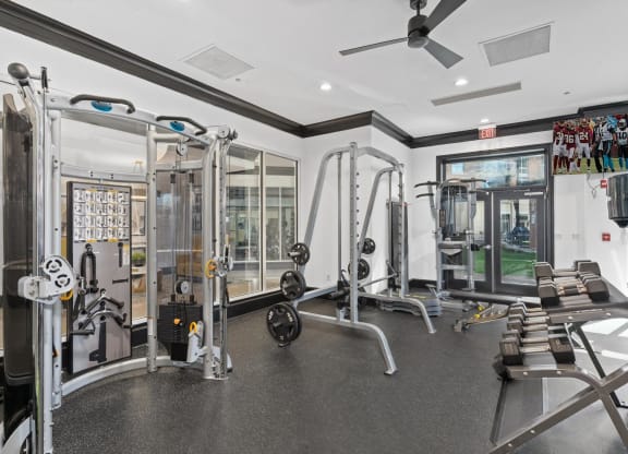 a home gym with weights and a ceiling fan
