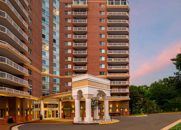 A large hotel with a white entrance and balconies.