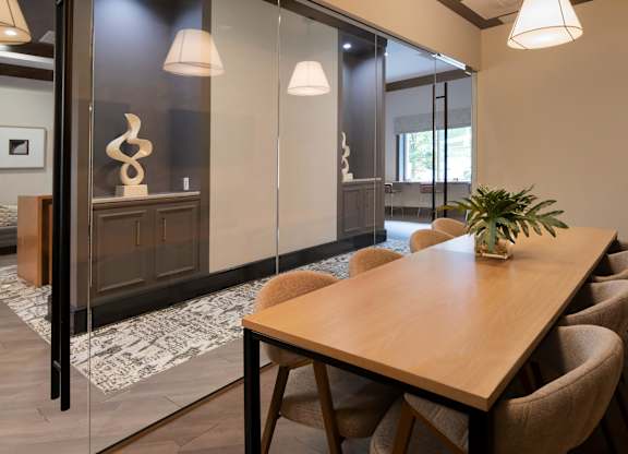 A conference room with a long table and chairs.