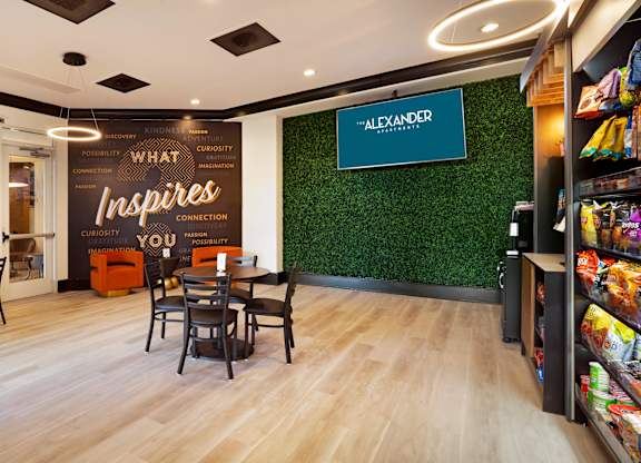 A store interior with wooden floors and a green wall with a sign that says "Alexander".