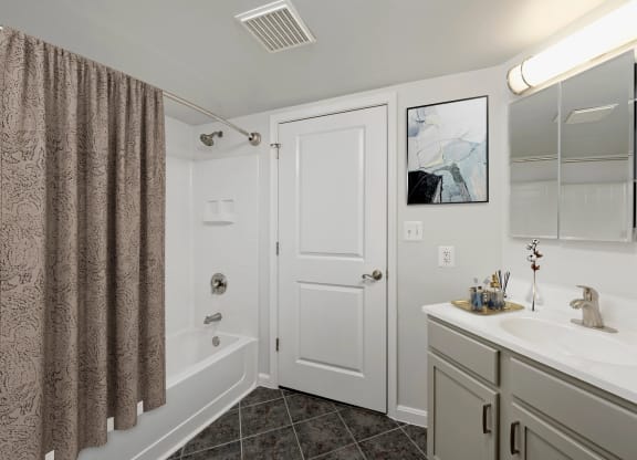 a bathroom with a shower and a sink and a mirror