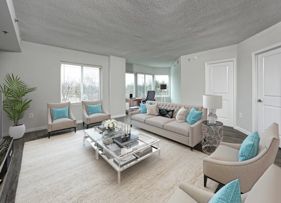 a living room with couches and chairs and a table