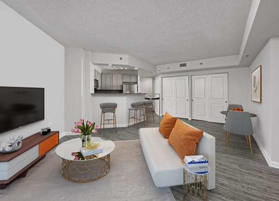 a living room and kitchen with a couch and a table