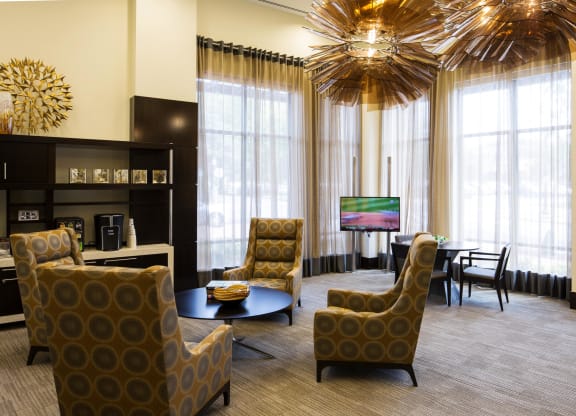 a living room with large windows and a large chandelier