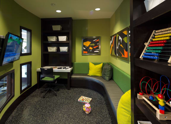 a childs play room with a desk and a chair