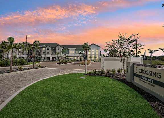 Entrance to The Crossing at Palm Aire during sunset