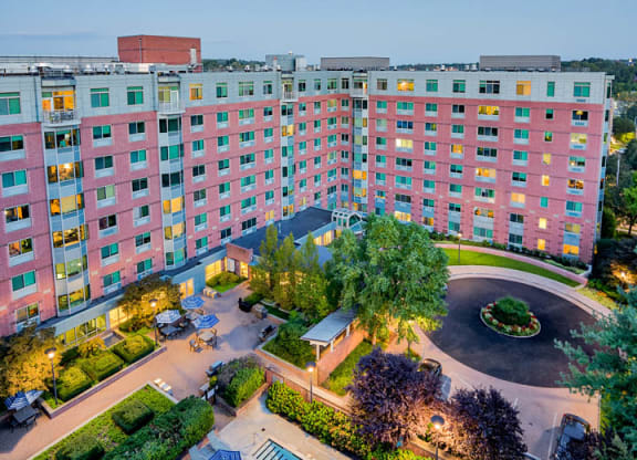 an aerial view of a hotel with a swimming pool