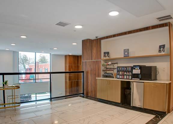 A reception area with a counter and a balcony with a view of the outside.