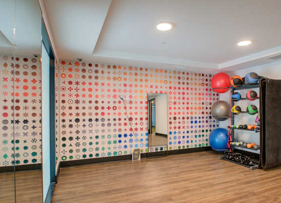 A room with a wall covered in buttons and a ball machine.