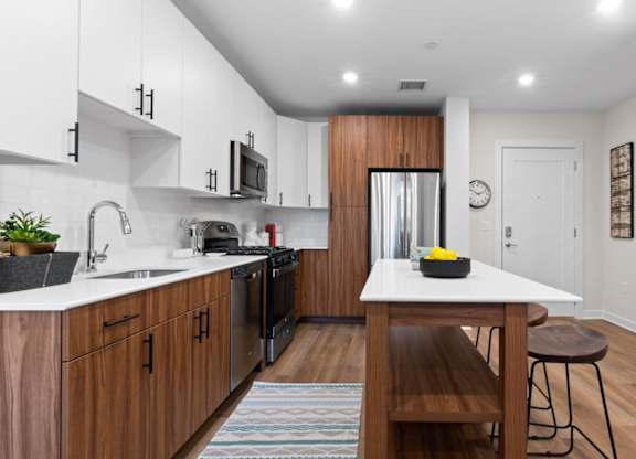 A modern kitchen with wooden cabinets and a white countertop.