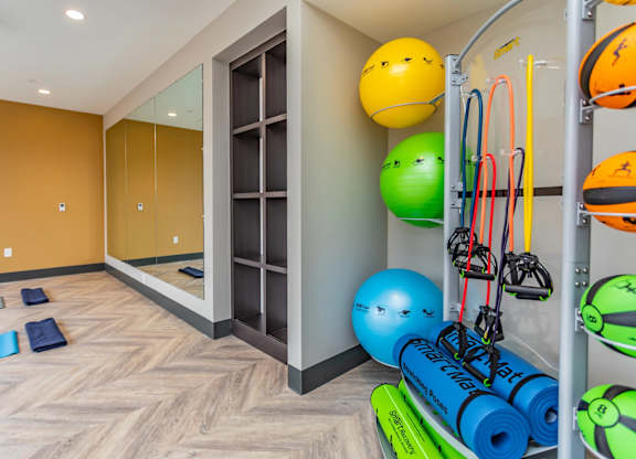 A gym with exercise equipment and a mirror.