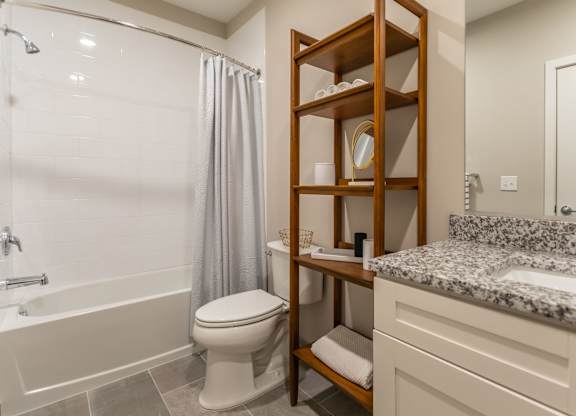 A bathroom with a toilet, sink, and shower.