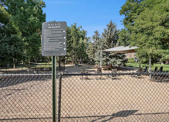 A sign in a park with a fence in the foreground at The Magwood in Boulder, Colorado.