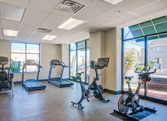 A gym with treadmills, exercise bikes, and elliptical machines.