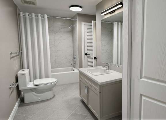 A white bathroom with a toilet, sink, and shower.