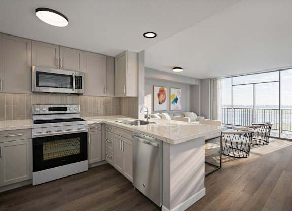 A modern kitchen with a large island and stainless steel appliances.