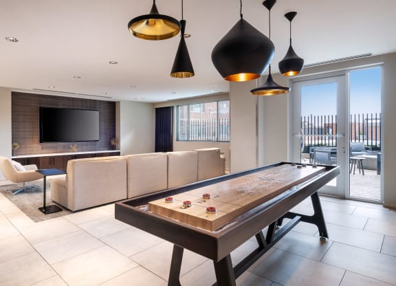 a living room with a pool table and a tv