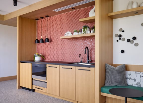 a kitchen with wooden cabinetry and a black counter top