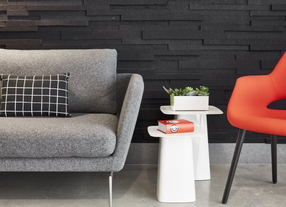 Stylish seating area with large chair and small coffee tables