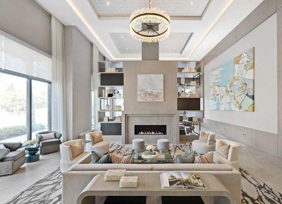 A modern living room with a fireplace and a chandelier.