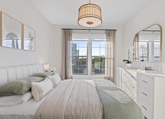 A bedroom with a large bed, a dresser, and a mirror.