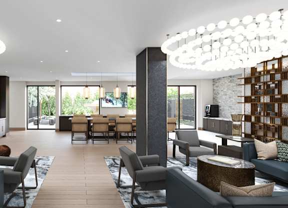 A modern living room with a large grey sofa and a wooden coffee table.
