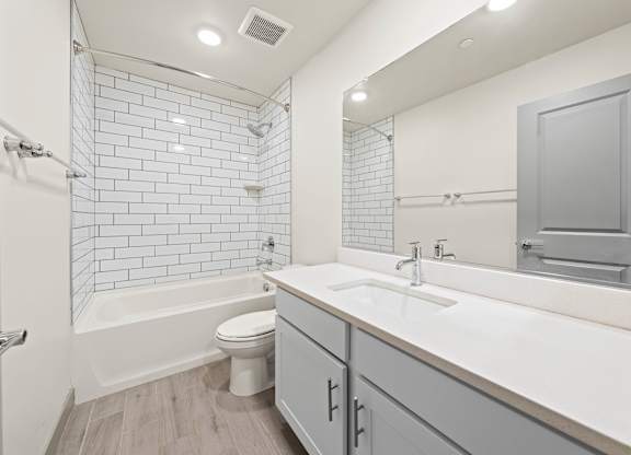 A white bathroom with a white toilet and a white sink.