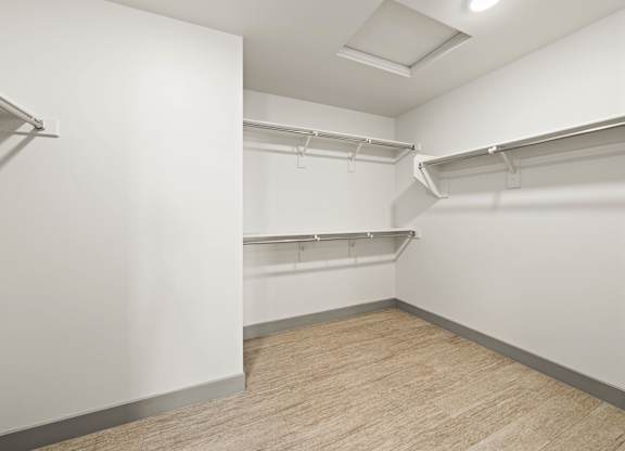 Empty room with white walls and wooden floor.