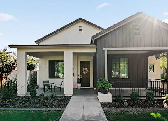 A modern house with a front porch and a covered entryway.
