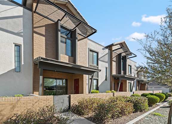 A modern house with a brown and beige exterior.