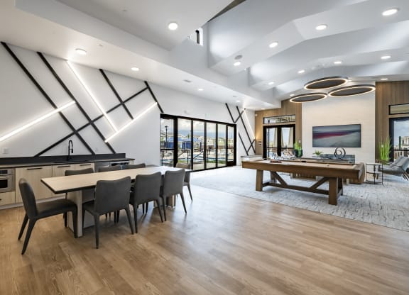 clubroom with a table and chairs and a billiards table
