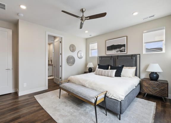 Furnished bedroom with ceiling fan and wood plank flooring