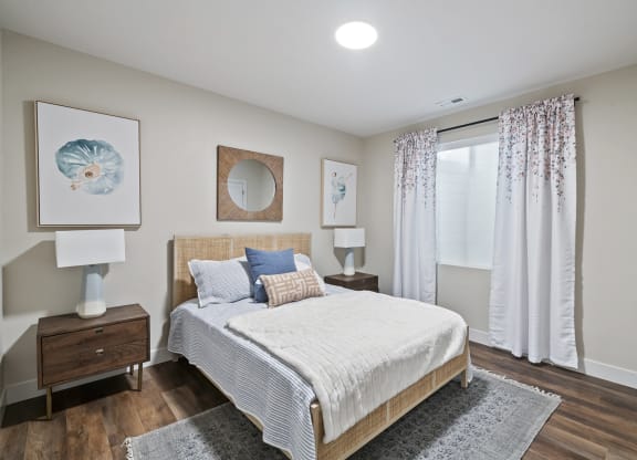 Furnished bedroom with wood plank flooring