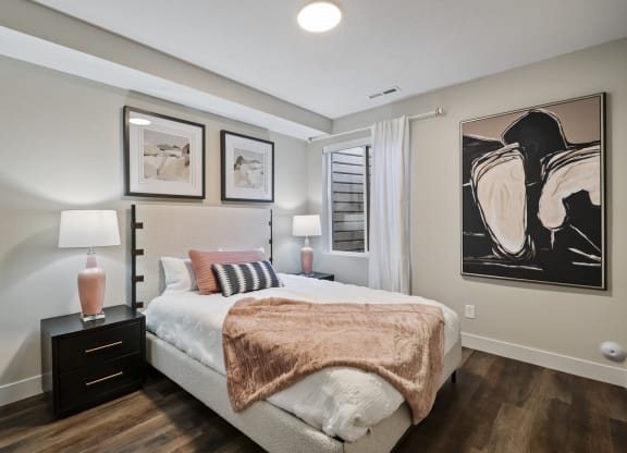 Furnished bedroom with wood plank flooring
