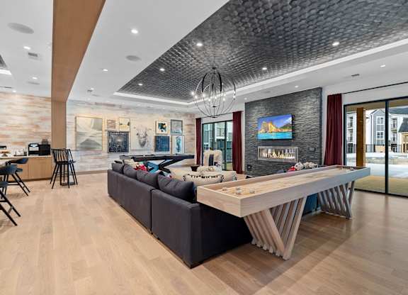 A modern living room with a large sectional sofa and a wooden coffee table.at 198 Milltown Apartments, Burlington  