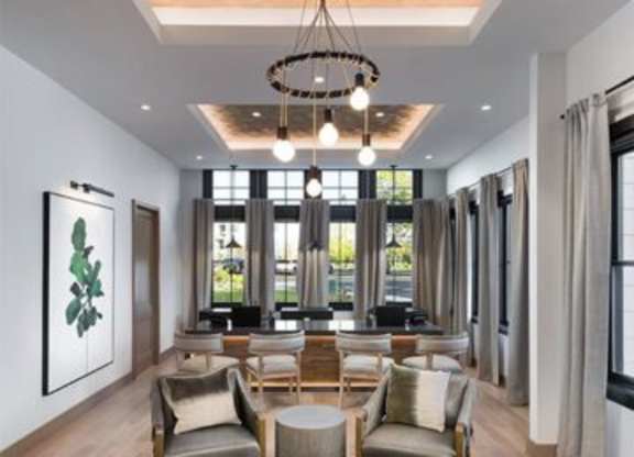 A modern living room with a large window and a hanging light fixture.at 198 Milltown Apartments, Burlington, 27215  