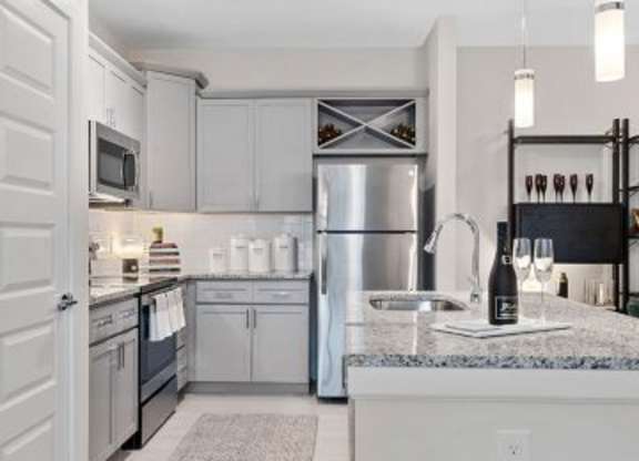 A kitchen with a refrigerator, microwave, and sink.at 198 Milltown Apartments, Burlington  