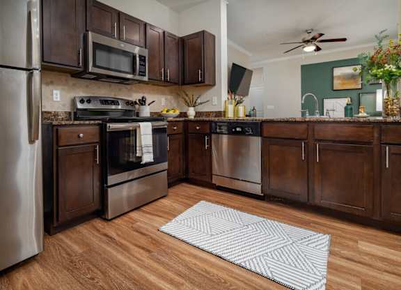 Kitchen with wooden cabinets at Pecan Springs, San Antonio, TX