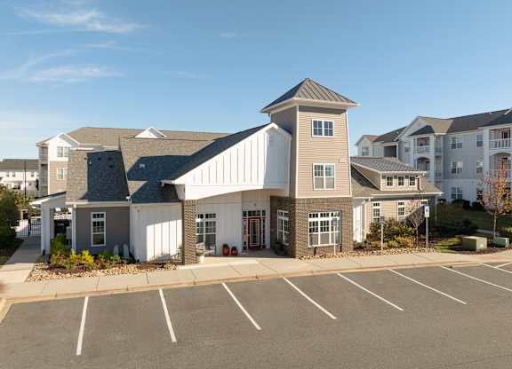 A large building with a parking lot in front of it. at Concord Ridge Apartments, Concord, North Carolina